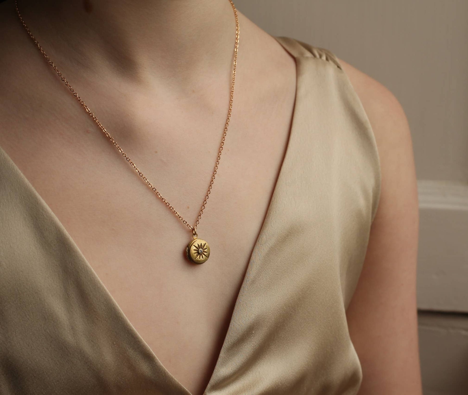 image of a lady wearing the compass locket