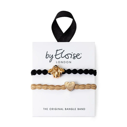 set of 2 hair bands. one is a black band with a gold bee motif and the other is  metallic gold band with a gold heart motif
